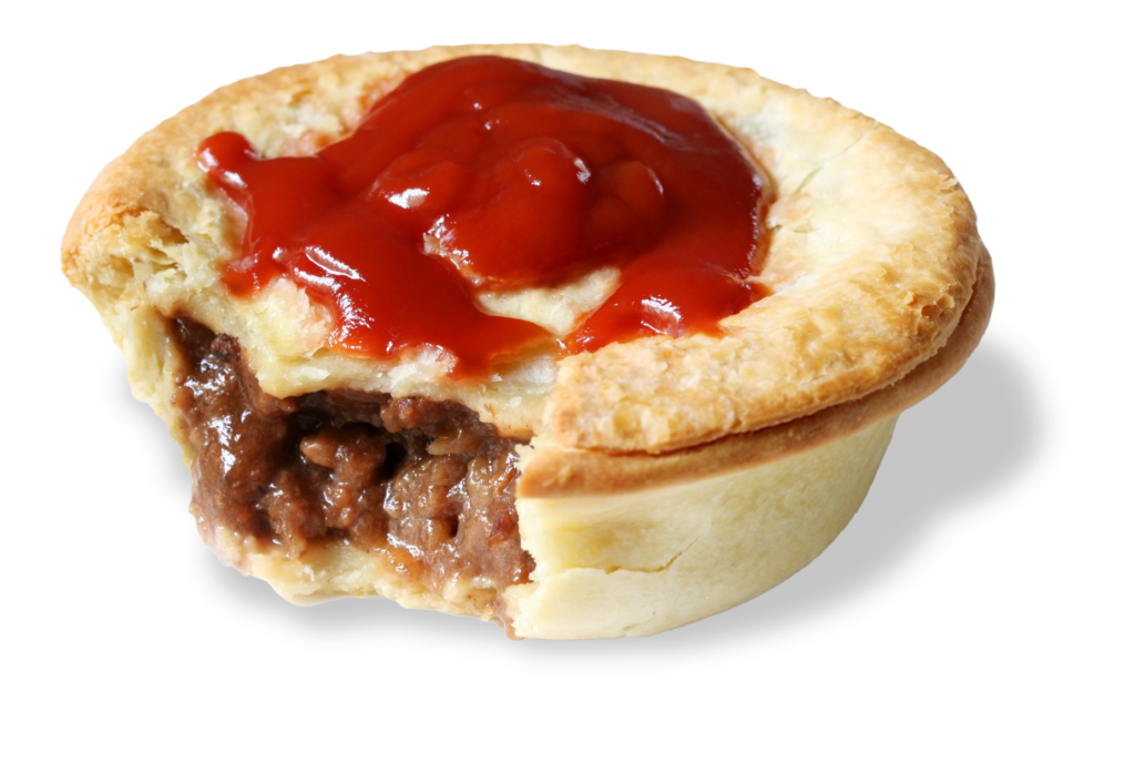 Hot meat pie with a bite taken out of it and tomato sauce on top